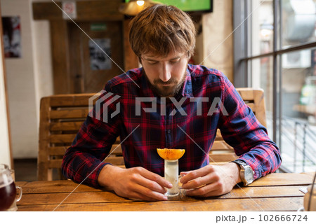 Alcoholism and the fight against alcohol addiction. A depressed man with alcohol 102666724