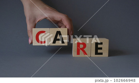 Care symbol. Concept word Care on wooden cubes. Businessman hand. Beautiful grey background. Business and Care concept. Copy space. Care symbol. Concept word Care on wooden cubes. Businessman hand. Beautiful grey background. Business and Care concept. Copy space. 102666948
