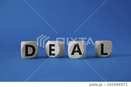 Deal symbol. Concept word Deal on wooden cubes. Beautiful blue background. Business and Deal concept. Copy space. 102666971