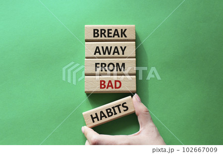 Break away from bad habits symbol. Wooden blocks with words Break away from bad habits. Beautiful green background. Businessman hand. Business and Break away from bad habits concept. Copy space. Break away from bad habits symbol. Wooden blocks with words Break away from bad habits. Beautiful green background. Businessman hand. Business and Break away from bad habits concept. Copy space. 102667009