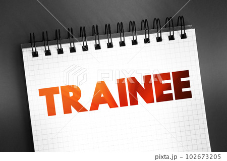 Trainee - commonly known as an individual taking part in a trainee program within an organization after having graduated from higher and technical courses, text concept on notepad Trainee - commonly known as an individual taking part in a trainee program within an organization after having graduated from higher and technical courses, text concept on notepad 102673205