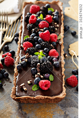 Chocolate ganache tart with fresh berries Chocolate ganache tart with fresh berries 102674832