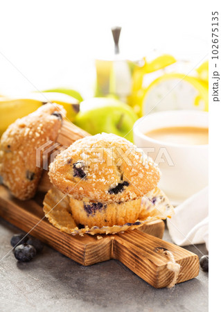 Blueberry and banana muffins with coffee for breakfast Blueberry and banana muffins with coffee for breakfast 102675135