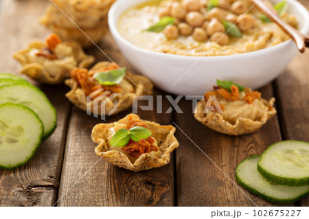 Homemade hummus in tortilla bowls 102675227