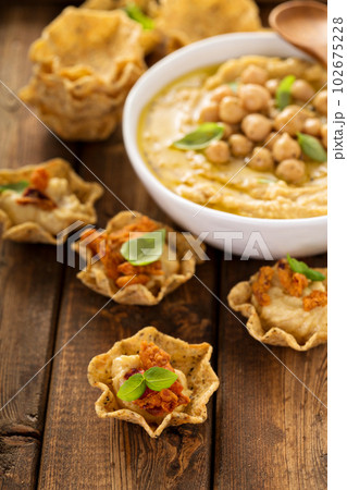 Homemade hummus in tortilla bowls 102675228