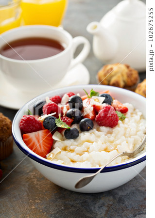 Rice pudding with fresh berries and coconut for breakfast Rice pudding with fresh berries and coconut for breakfast 102675255