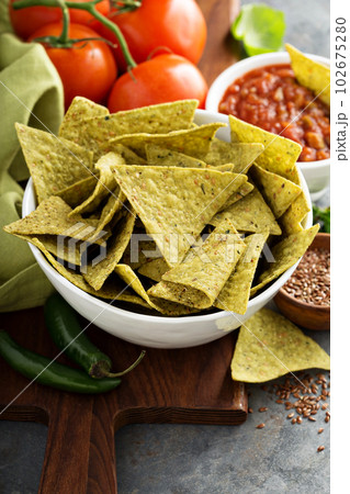 Healthy corn tortilla chips with spinach and flax seeds 102675280