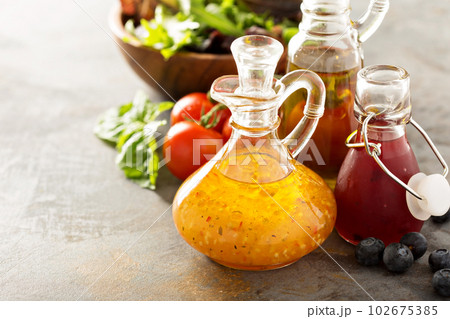 Assortment of salad dressings in glass bottles Assortment of salad dressings in glass bottles 102675385