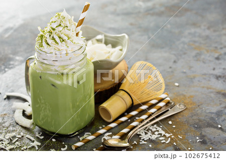 Iced matcha latte with coconut cream 102675412