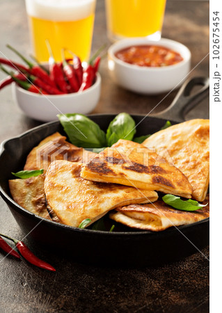 Cheese quesadillas in a cast iron pan 102675454
