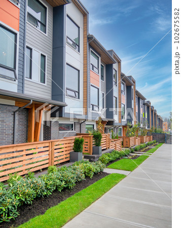 Walkway along a row of brand new townhouses on sale stage Walkway along a row of brand new townhouses on sale stage 102675582
