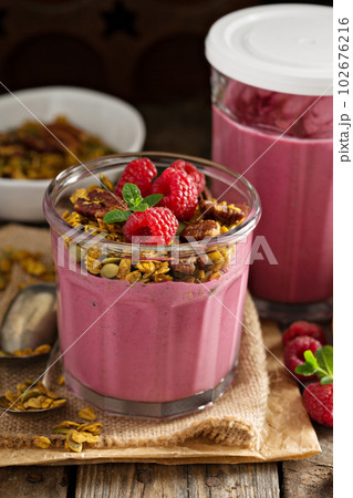 Healthy orange and raspberry smoothie 102676216