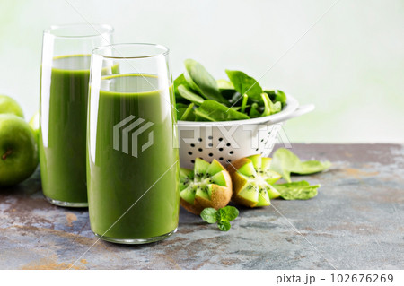 Green juice in tall glasses 102676269