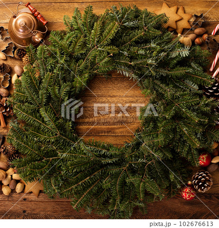 Christmas pine wreath with spices and candy cones 102676613