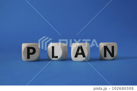 Plan symbol. Concept word Plan on wooden cubes. Beautiful blue background. Business and Plan concept. Copy space. Plan symbol. Concept word Plan on wooden cubes. Beautiful blue background. Business and Plan concept. Copy space. 102680308