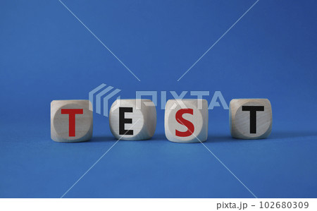 Test symbol. Concept word Test on wooden cubes. Beautiful blue background. Business and Test concept. Copy space. Test symbol. Concept word Test on wooden cubes. Beautiful blue background. Business and Test concept. Copy space. 102680309