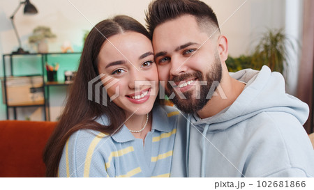 Portrait of happy smiling family marriage couple man woman looking at camera, hugging, embracing 102681866