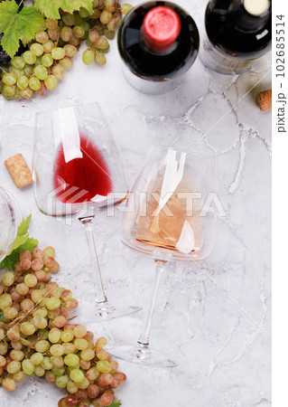 Rose and red wine glasses and bottles Rose and red wine glasses and bottles 102685514