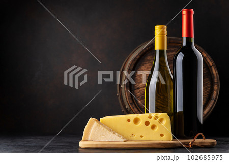 Various cheese on board, red and white wine 102685975
