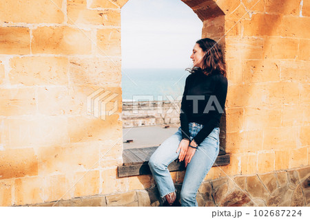 Young cheerful woman enjoing sunny day on the beach 102687224