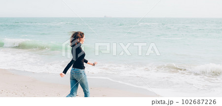 Young cheerful woman enjoing sunny day on the beach Young cheerful woman enjoing sunny day on the beach 102687226