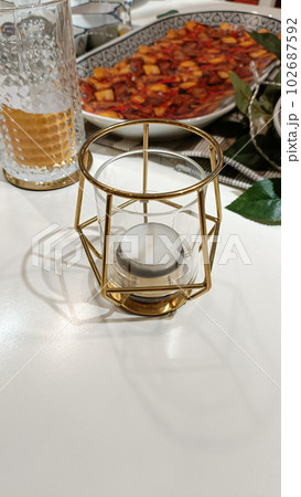 Unique candle holder on the table. 102687592