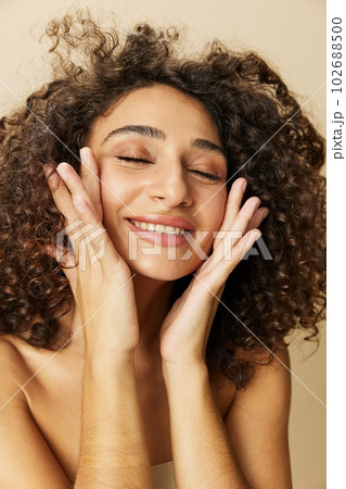 Woman beauty face close-up skin health nails and hair, hair dryer style curly afro hair, body and beauty care concept 102688500