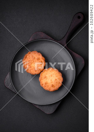 Delicious baked cupcake or tartlet with cheese and raisins Delicious baked cupcake or tartlet with cheese and raisins 102689422