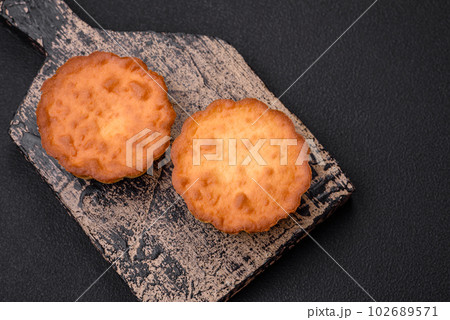 Delicious baked cupcake or tartlet with cheese and raisins 102689571