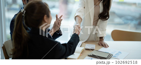 Young business people shaking hands in the office. Finishing successful meeting 102692518