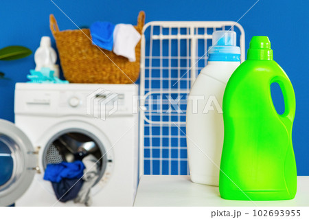 Bottle of detergent whith washing machine, indoors Bottle of detergent whith washing machine, indoors 102693955