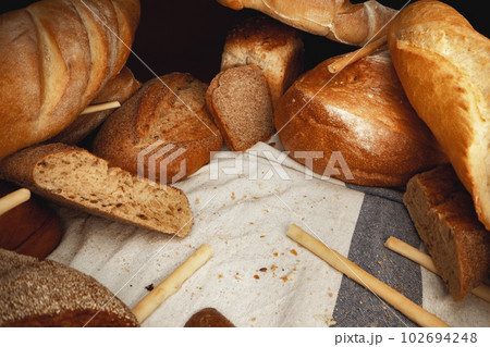 Variety of bread on tablecloth close up Variety of bread on tablecloth close up 102694248