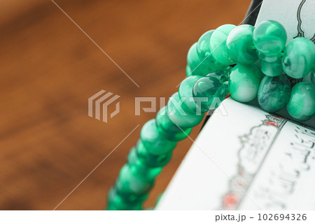 Oriental religious beads close up on a wooden table 102694326