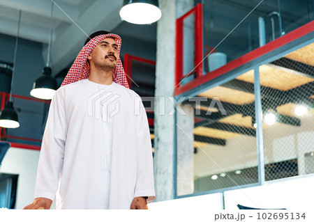 Successful muslim businessmen in traditional outfit in his office 102695134