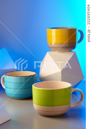 Colorful clay ceramic cups on gray background 102695404