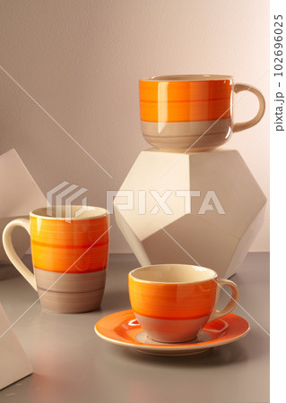 Colorful clay ceramic cups on gray background Colorful clay ceramic cups on gray background 102696025