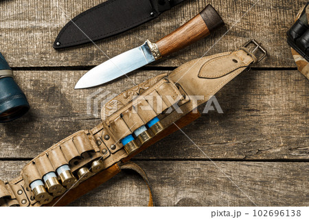 Various hunting equipment on old wooden background Various hunting equipment on old wooden background 102696138