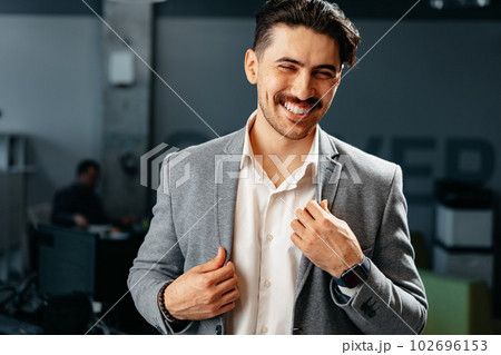Confident Arab businessman in formal clothes standing in office Confident Arab businessman in formal clothes standing in office 102696153