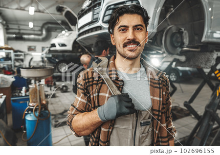 Portrait of a male mechanic in an auto repair shop Portrait of a male mechanic in an auto repair shop 102696155
