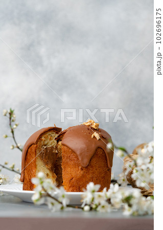 Cut Easter cake on plate decorated with spring flower branches 102696175