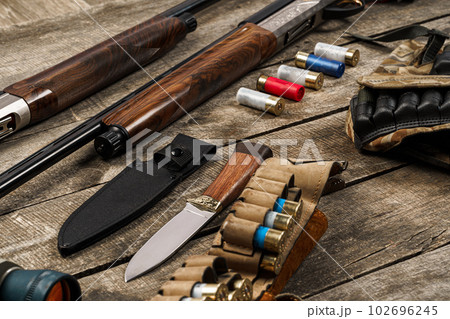 Various hunting equipment on old wooden background Various hunting equipment on old wooden background 102696245