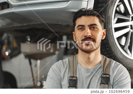 Portrait of a male mechanic in an auto repair shop Portrait of a male mechanic in an auto repair shop 102696459