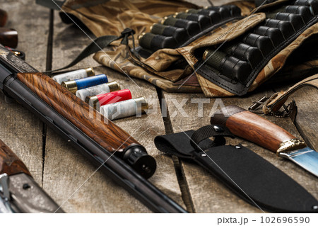 Various hunting equipment on old wooden background Various hunting equipment on old wooden background 102696590