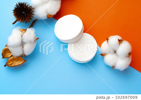 Cotton flower and cotton discs on paper background 102697009
