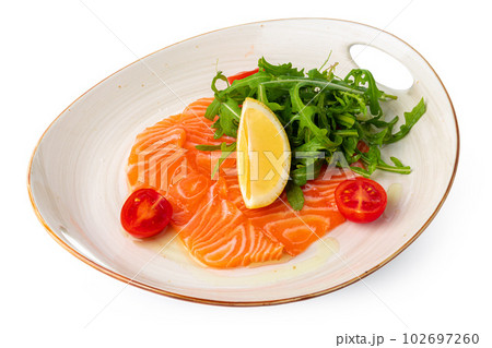 Salmon carpaccio with arugula isolated on white Salmon carpaccio with arugula isolated on white 102697260