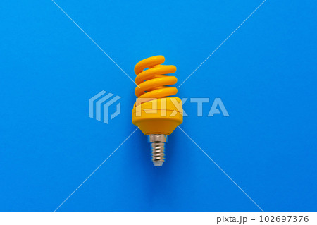 One light bulb on a blue paper background One light bulb on a blue paper background 102697376