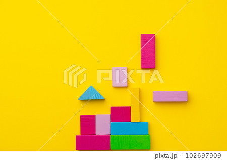 Toy kid's constructor on yellow background top view 102697909