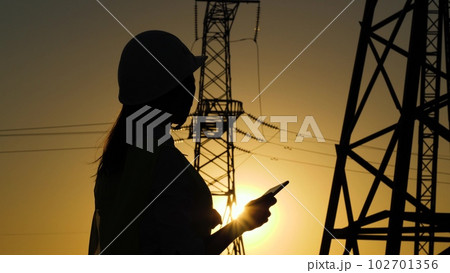 Electrical Engineer. engineer work tablet sunset. towers electricity work. work digital helmets. voltage engineers electrical silhouette. industry technology tablet. computer engineer. working using 102701356