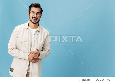 Portrait of a stylish man smile with teeth in glasses for farsightedness and myopia, on a blue background in a white T-shirt, fashionable clothing style, space space Portrait of a stylish man smile with teeth in glasses for farsightedness and myopia, on a blue background in a white T-shirt, fashionable clothing style, space space 102701751