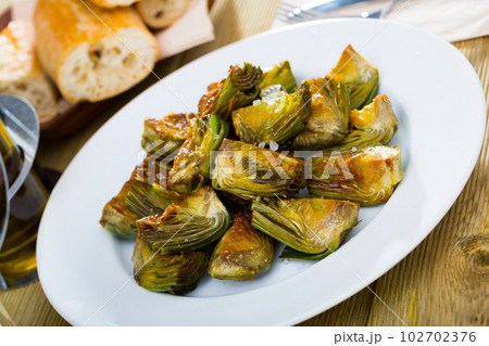 Appetizing artichokes fried in oil Appetizing artichokes fried in oil 102702376